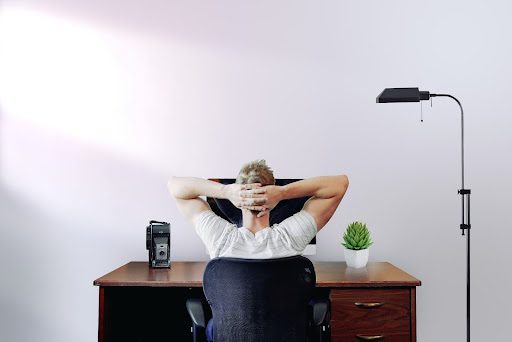  a guy sitting on an ergonomic computer chair